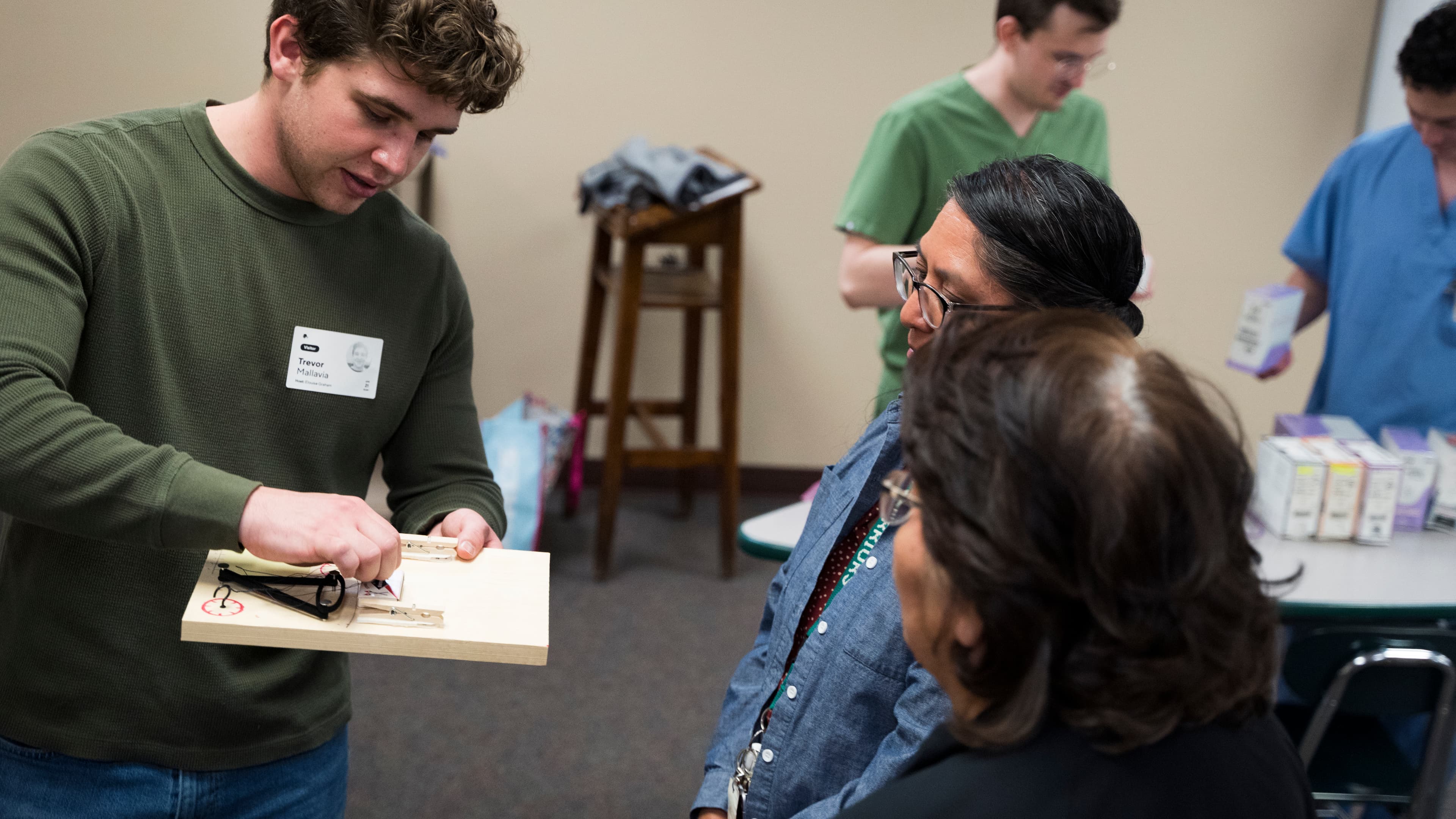Student showing the take-home suturing practice kit