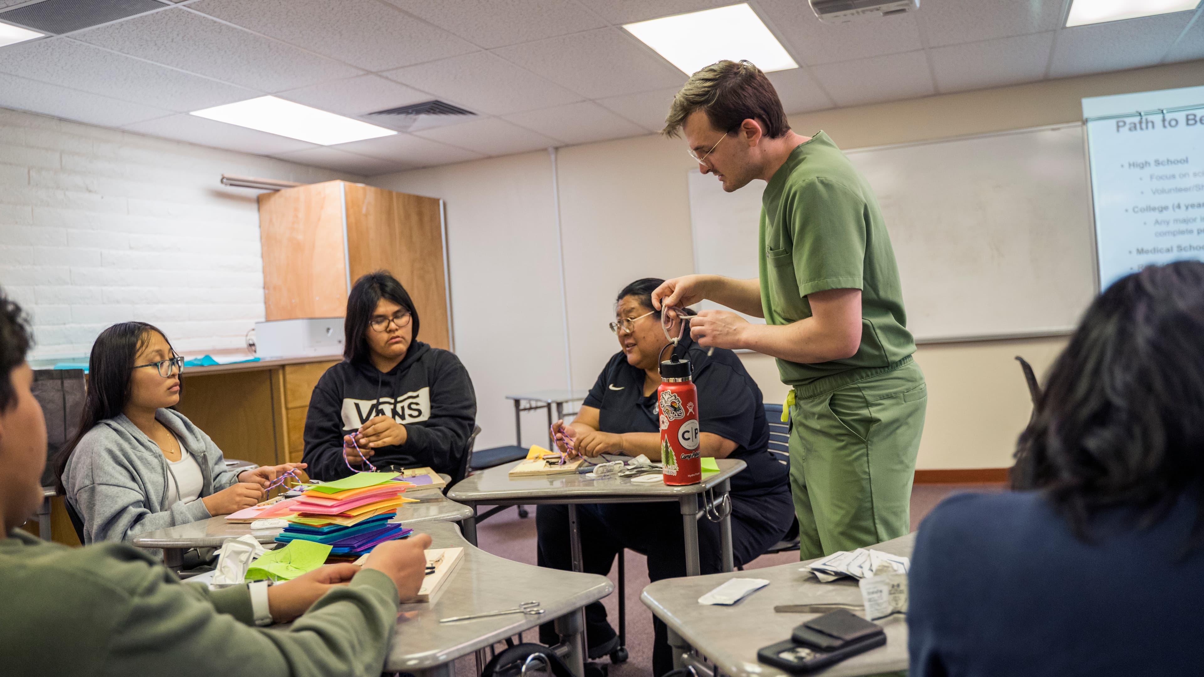 Sam working with students on suturing skills
