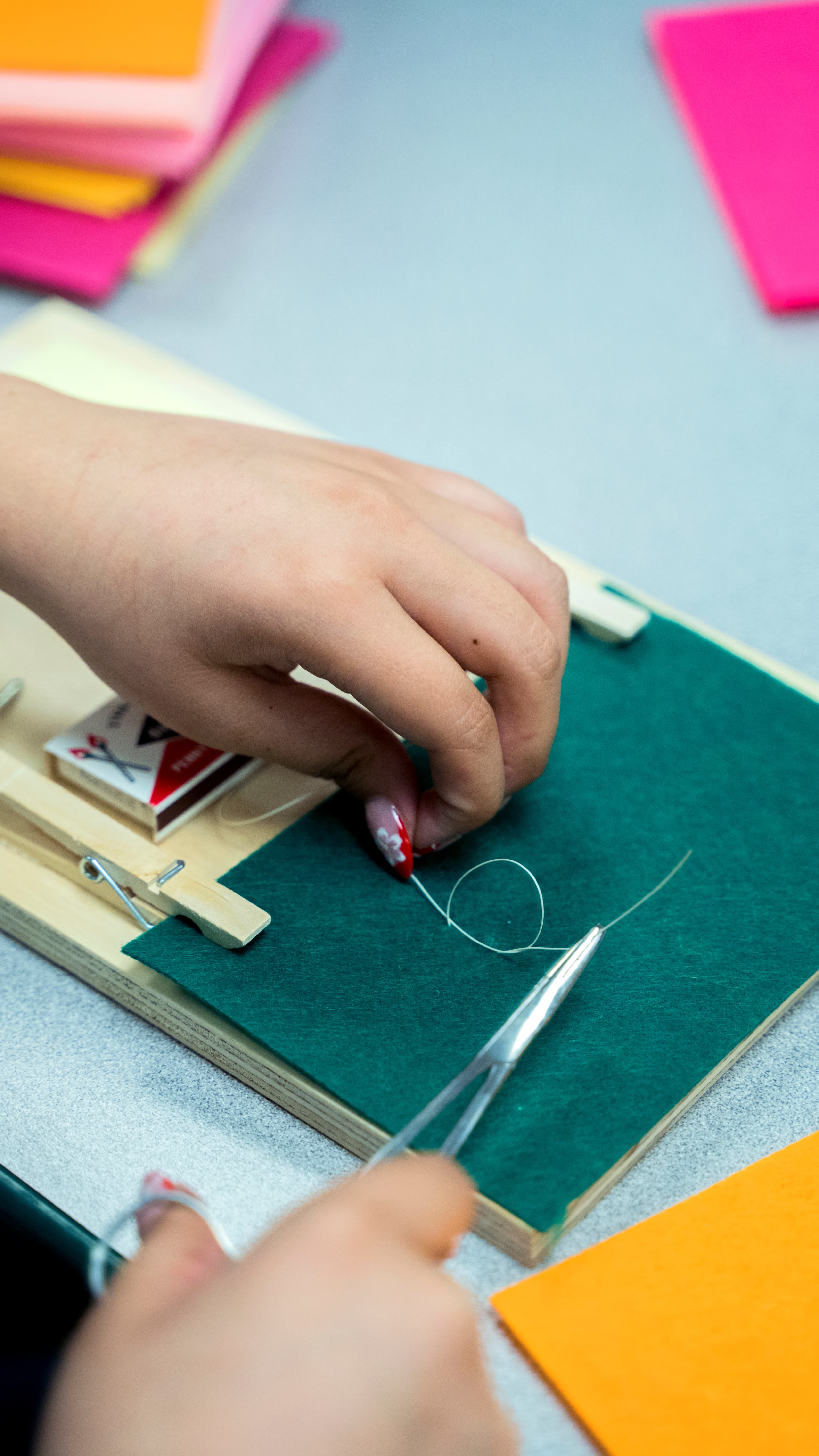 Close-up of a student practicing suturing on felt