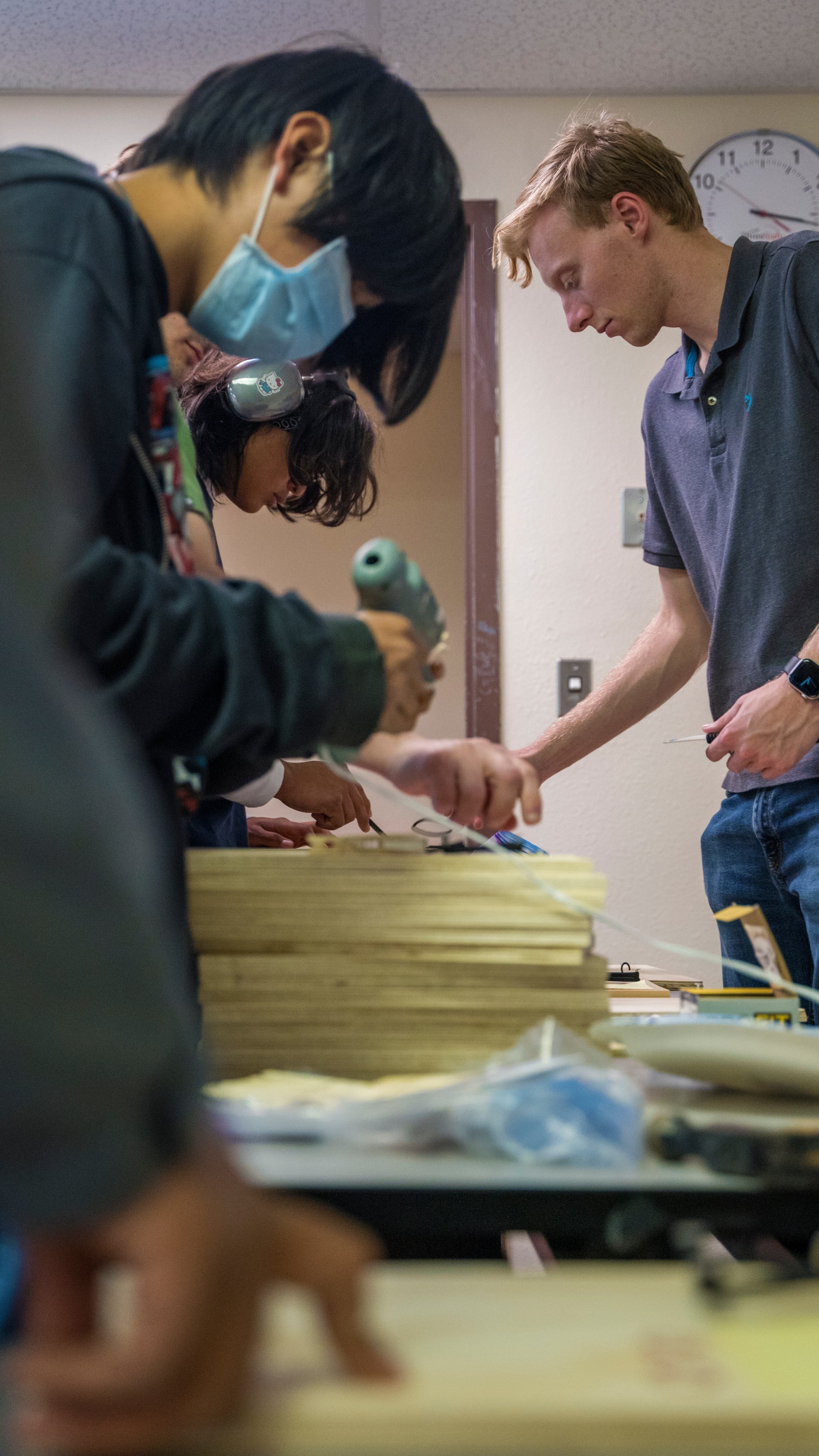 Dylan assisting students as they prepare practice kits