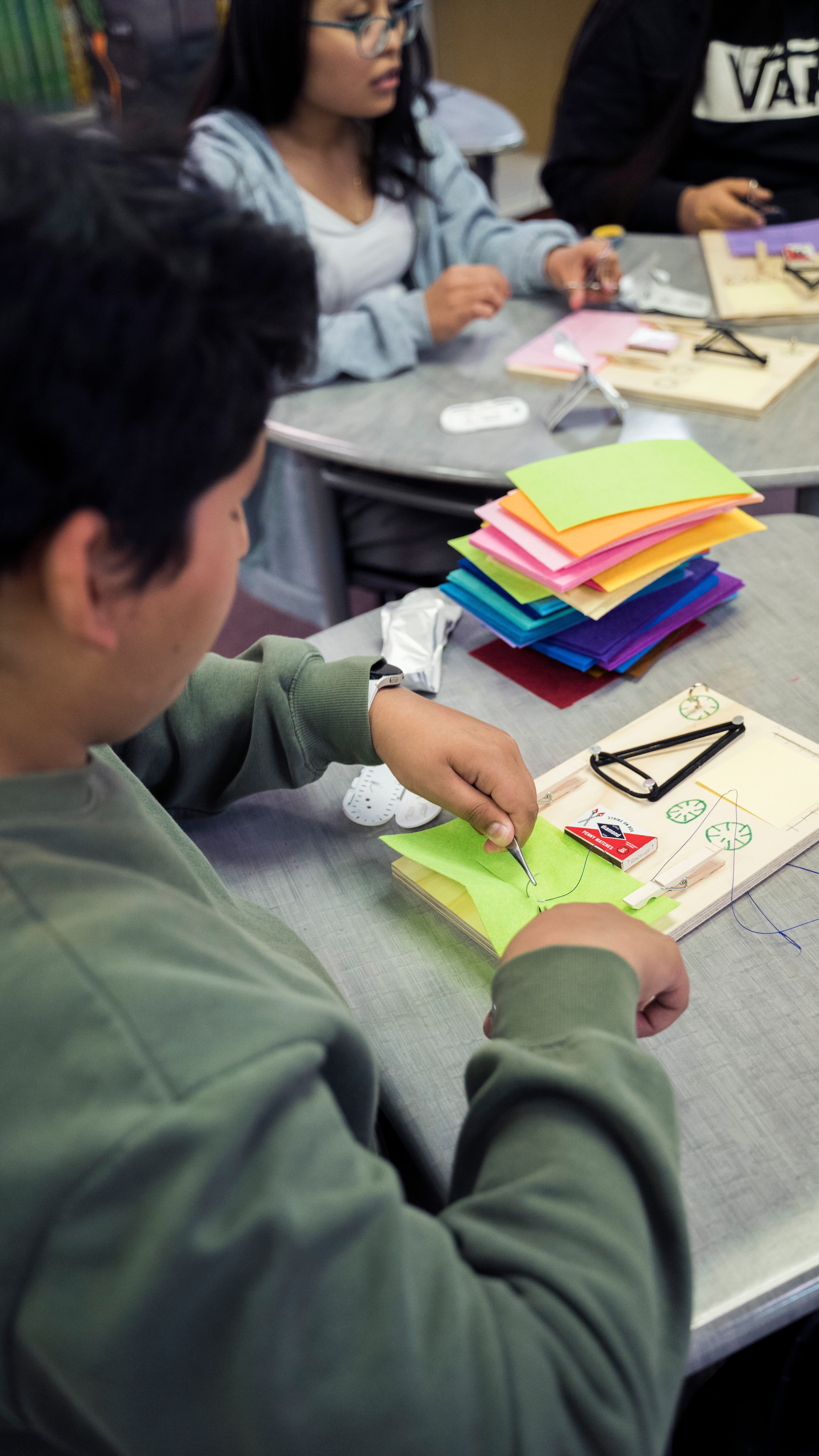 Student focusing while suturing on felt material